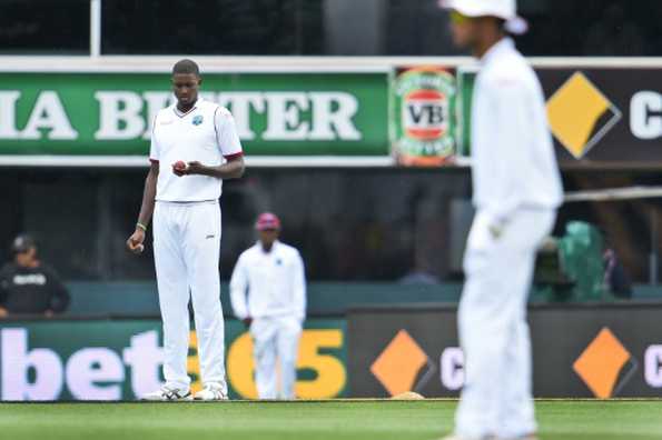 West Indies captain Jason Holder looks at the ball while bowling to Australia on the second day of the first cricket Test match in Hobart on December 11, 2015 West Indies captain Jason Holder looks at the ball while bowling to Australia on the second day of the first cricket Test match in Hobart on December 11, 2015