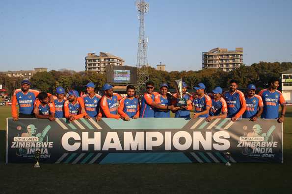Indian players pose with the winners cheque after the series win
