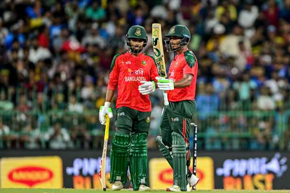 Tanzid Hasan acknowledges the crowd after reaching 50 