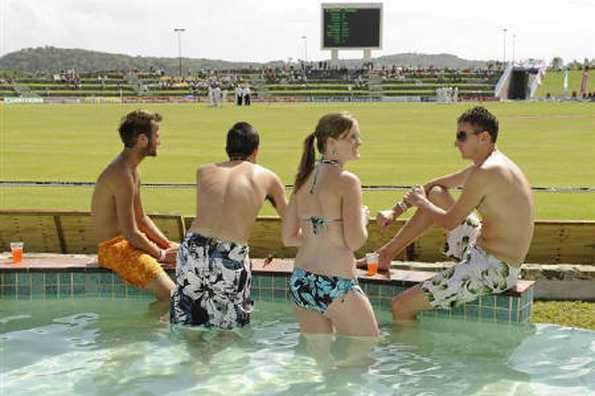 Fans in the pool watch as play was abandoned for the day at the Sir Vivian Richards Stadium in North Sound February 13, 2009. REUTERS/Philip Brown Fans in the pool watch as play was abandoned for the day at the Sir Vivian Richards Stadium in North Sound February 13, 2009. REUTERS/Philip Brown