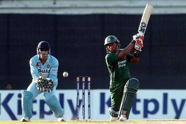 Bangladeshi batsman Raqibul Hasan hits a ball as Indian wicketkeeper MS Dhoni looks on in Dhaka. Bangladeshi batsman Raqibul Hasan hits a ball as Indian wicketkeeper MS Dhoni looks on in Dhaka.